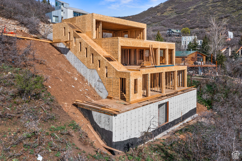 Back of property with a mountain view