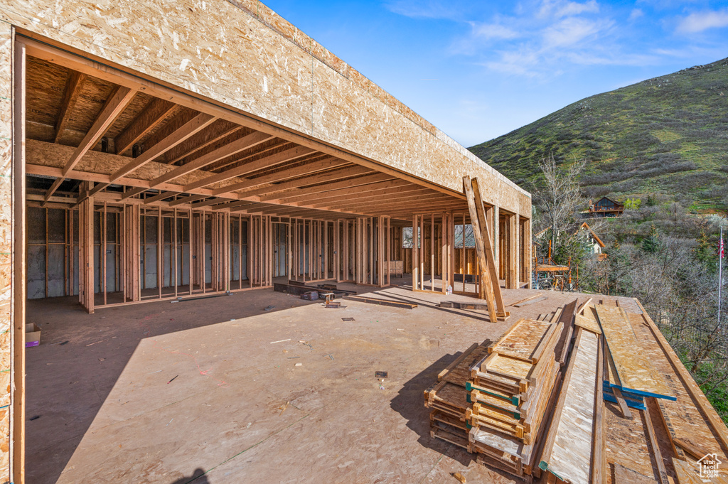 View of patio / terrace featuring a mountain view and an outbuilding