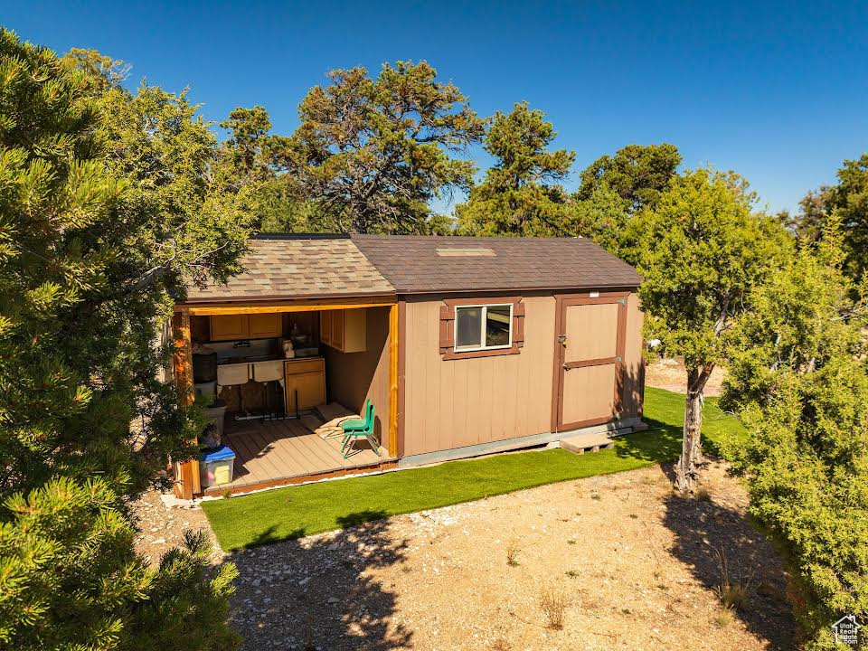 View of outbuilding with a yard