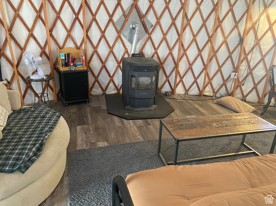 Interior space with dark wood-type flooring and a wood stove