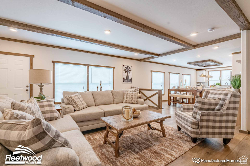 Living room featuring beamed ceiling and light hardwood / wood-style floors