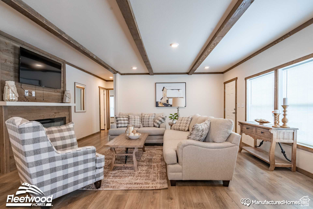 Living room with hardwood / wood-style floors and beam ceiling