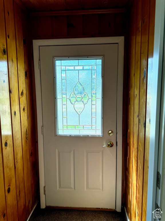 Doorway to outside featuring carpet flooring and plenty of natural light