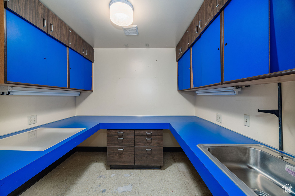 Kitchen with light tile patterned flooring and sink