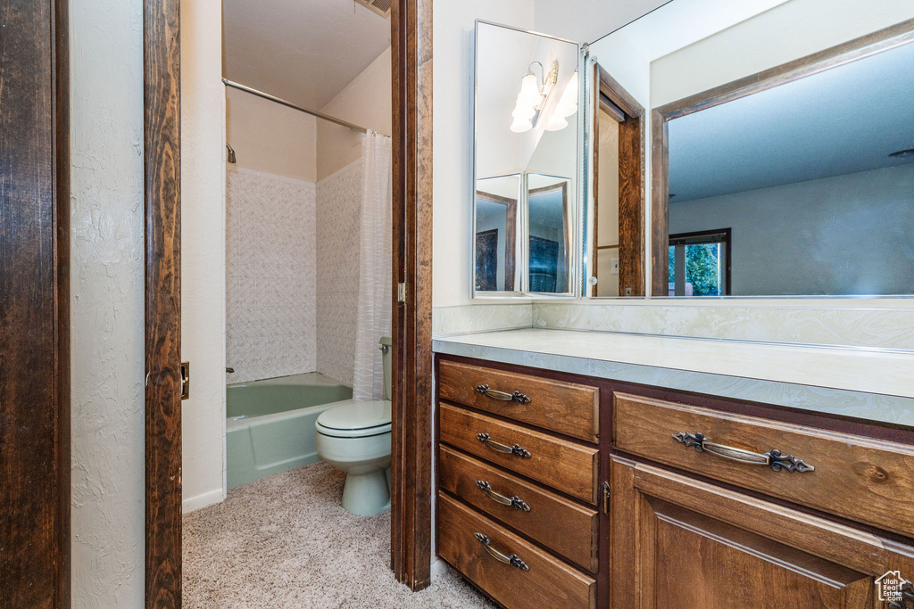 Full bathroom with toilet, vanity, and shower / bath combination with curtain