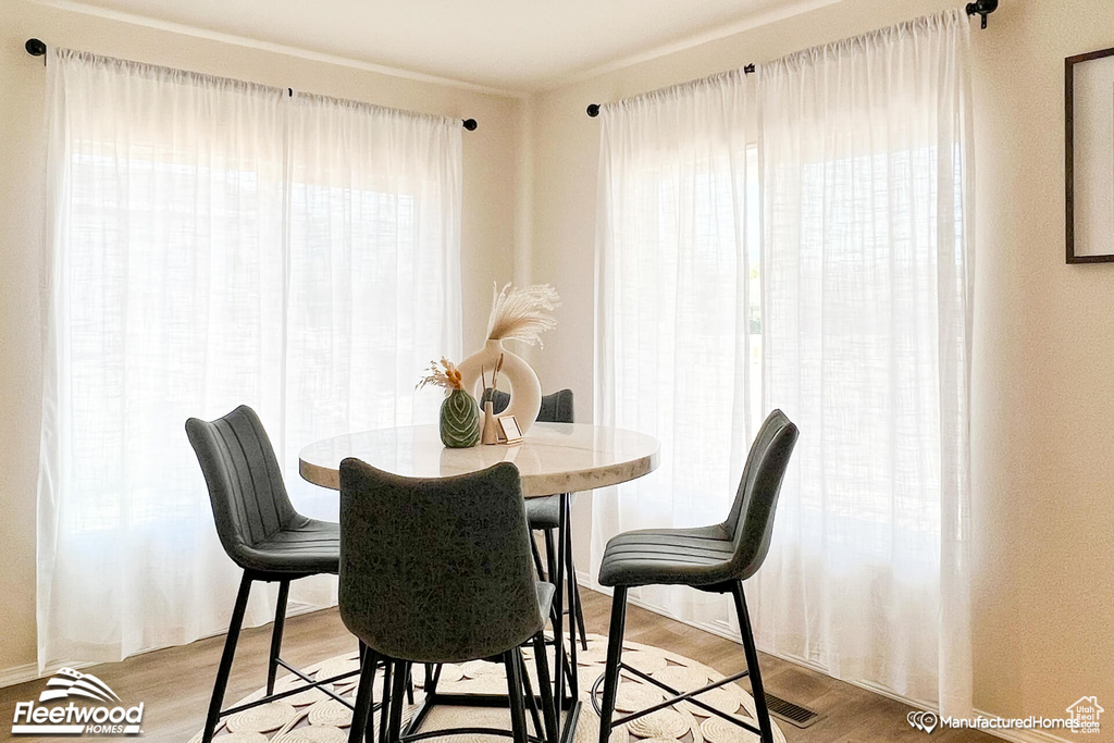 Dining area with plenty of natural light and light wood-type flooring