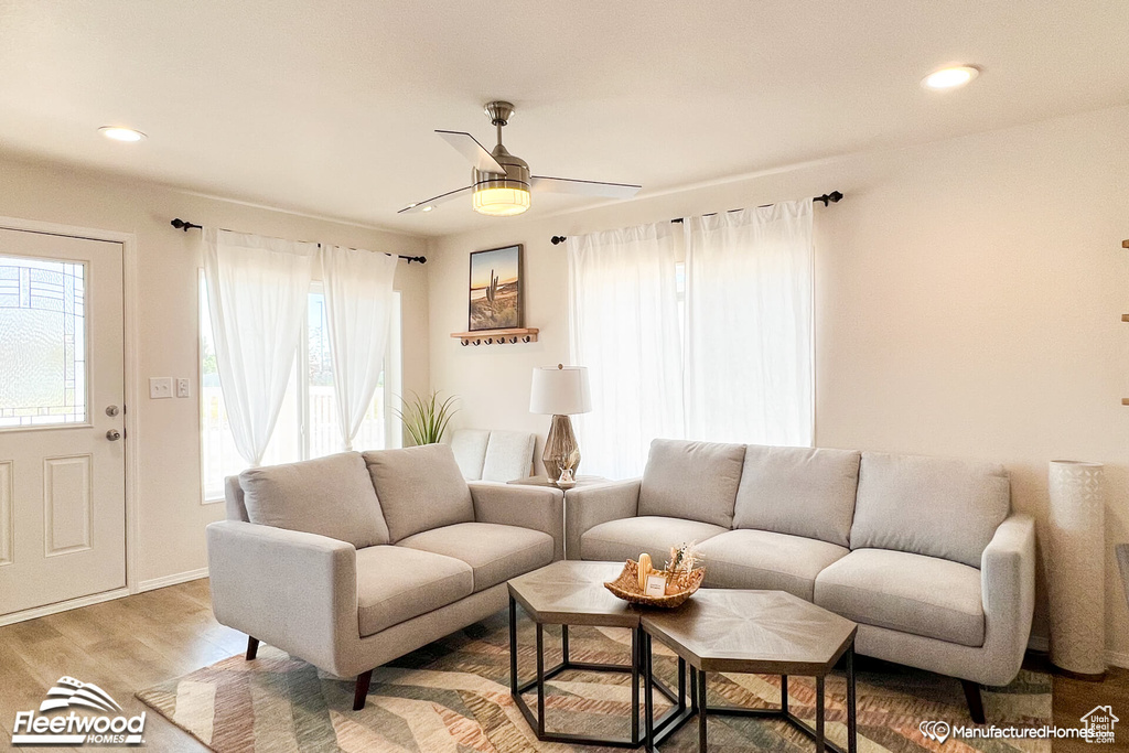 Living room featuring ceiling fan and light hardwood / wood-style floors