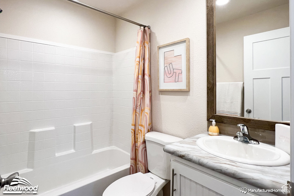 Full bathroom featuring vanity, shower / bathtub combination with curtain, and toilet