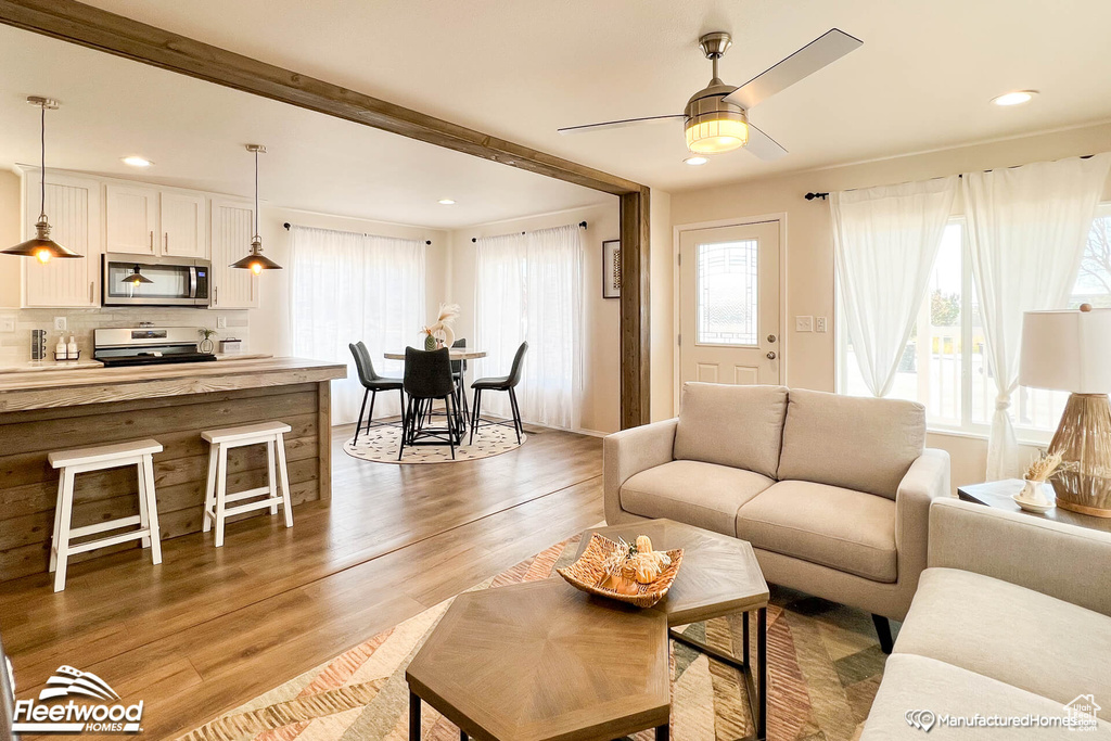 Living room featuring light hardwood / wood-style flooring and ceiling fan