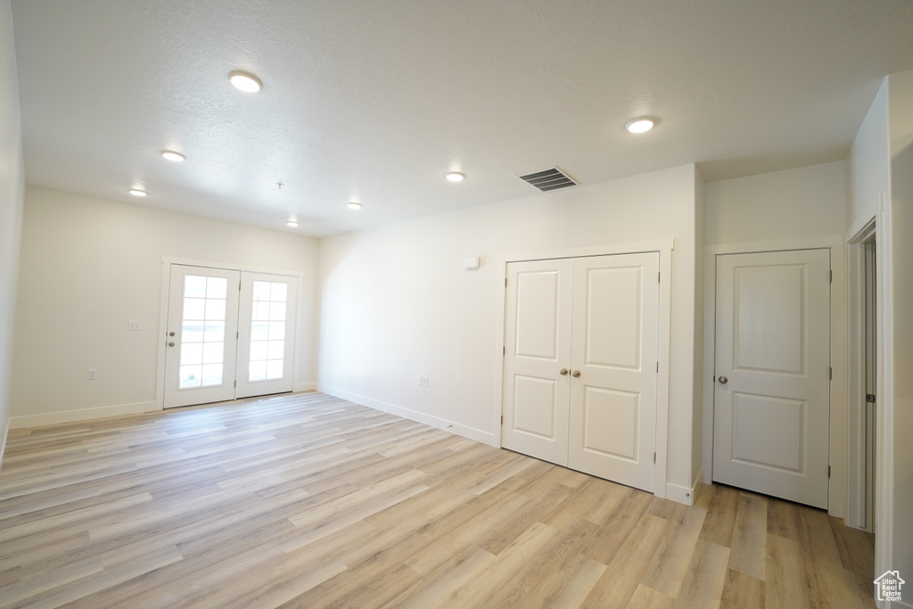 Empty room with light hardwood / wood-style flooring