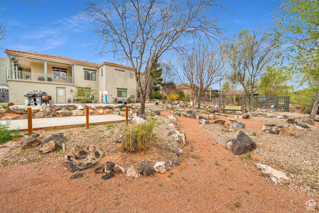 View of yard featuring a balcony
