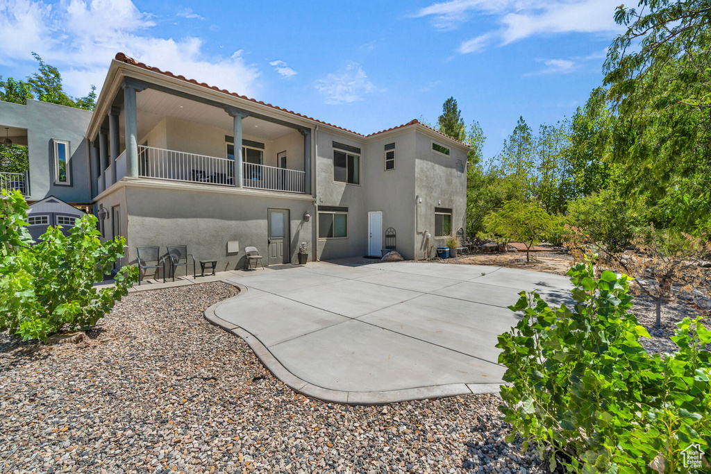 Back of property with a patio and a balcony