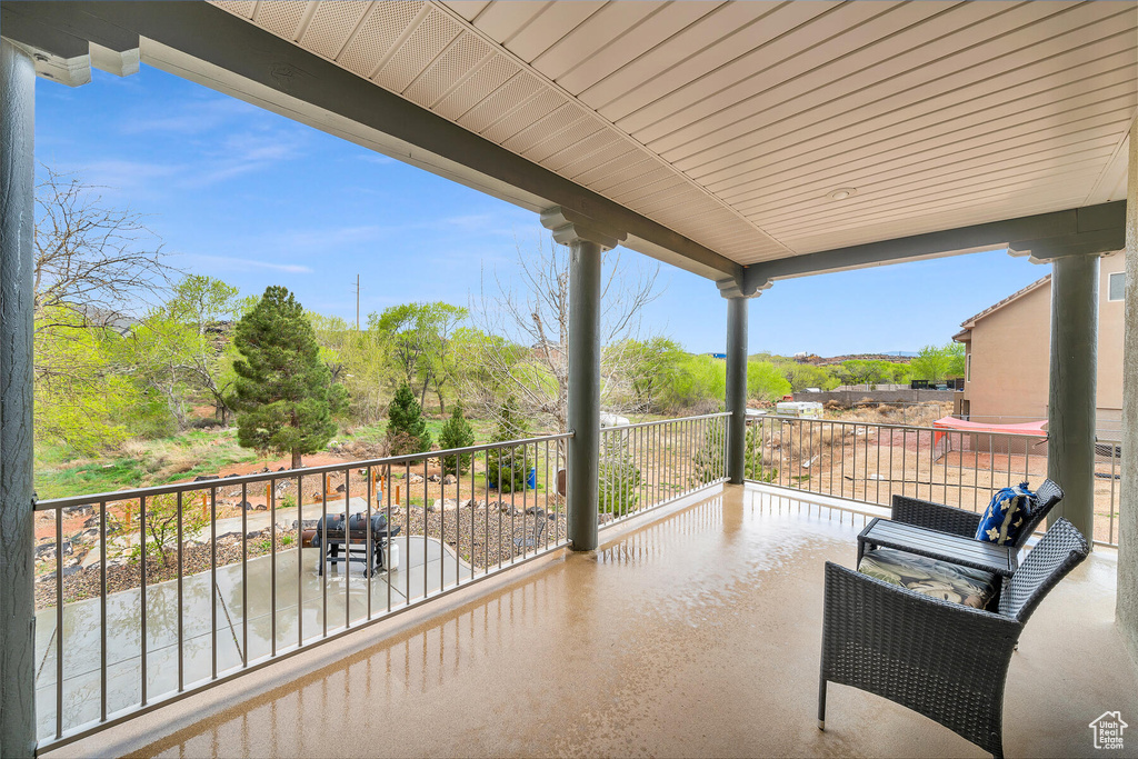 View of patio with a balcony