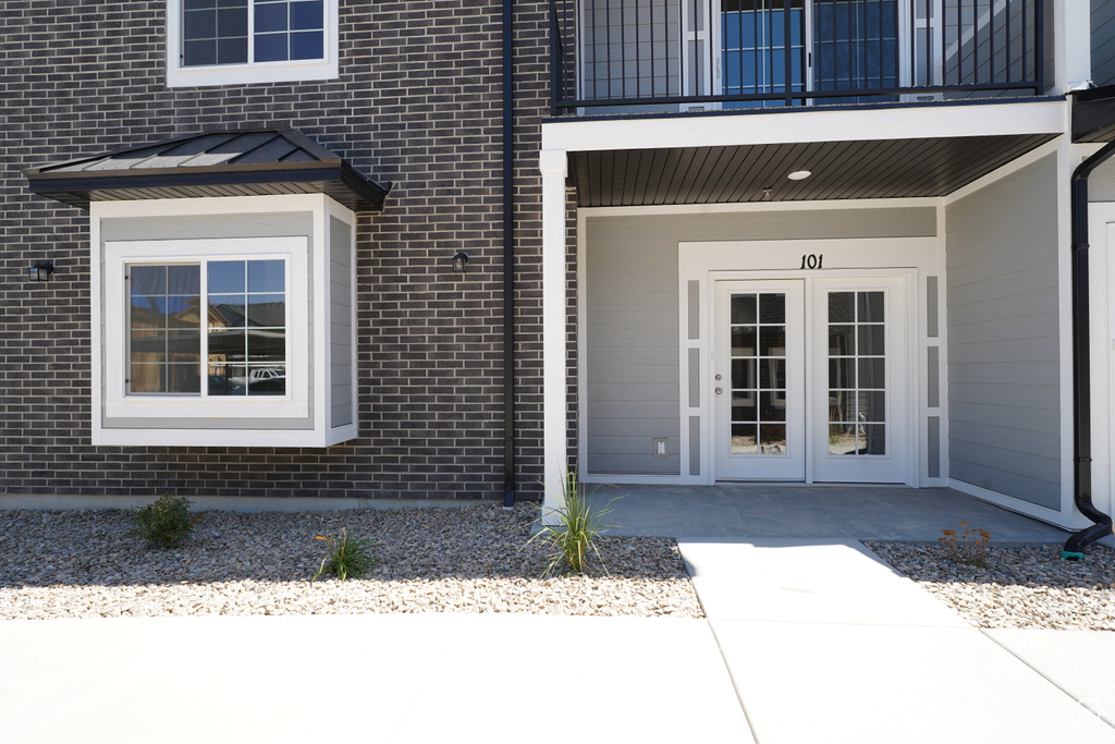 Entrance to property featuring a balcony and french doors