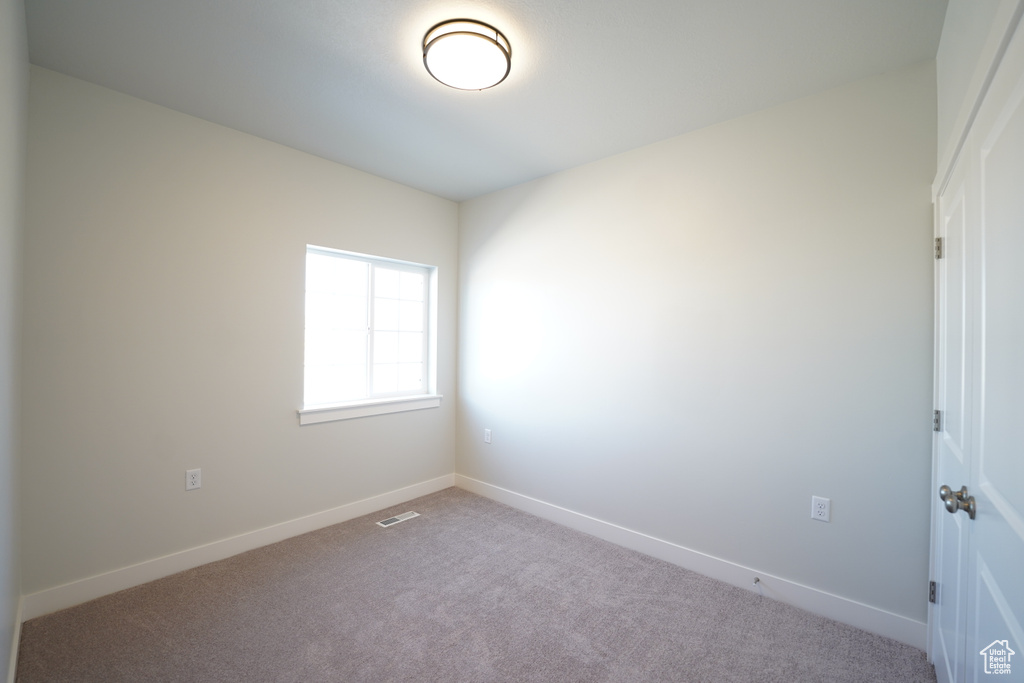 Spare room featuring carpet flooring