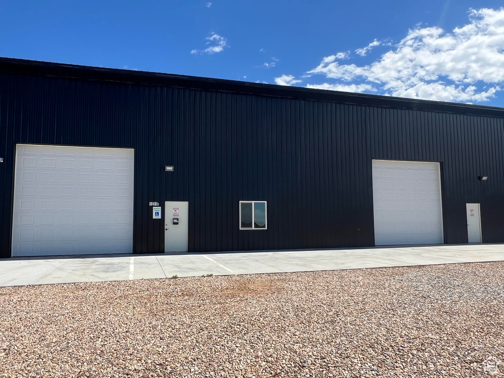 Exterior space featuring an outbuilding and a garage