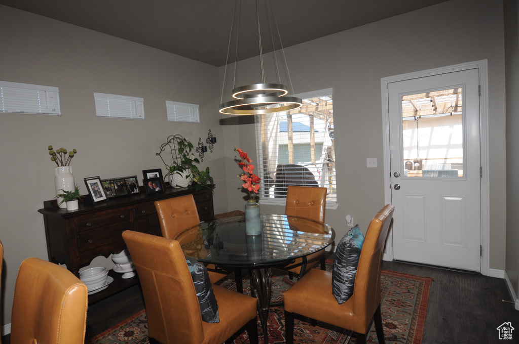 Dining space with dark wood-type flooring