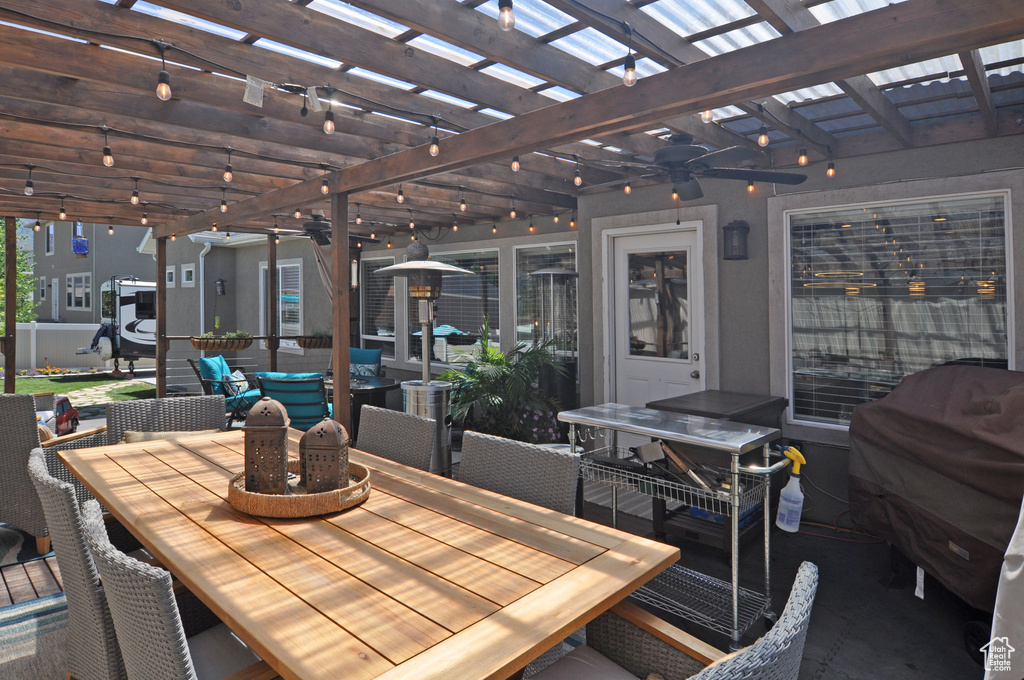 View of patio with grilling area, an outdoor hangout area, and a pergola