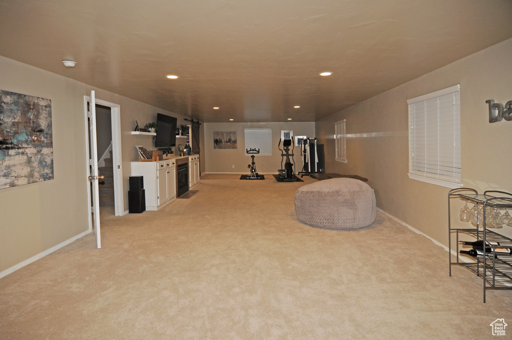 Sitting room featuring light colored carpet and beverage cooler