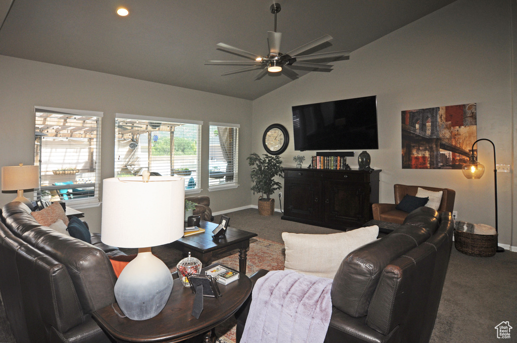 Living room with ceiling fan, carpet, and vaulted ceiling