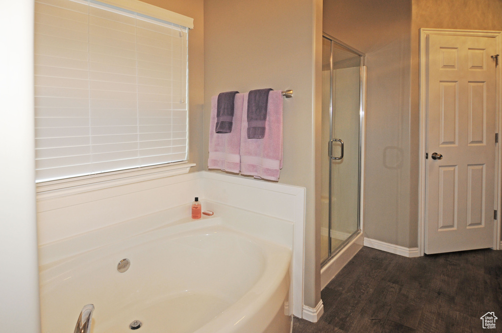 Bathroom featuring hardwood / wood-style floors and separate shower and tub