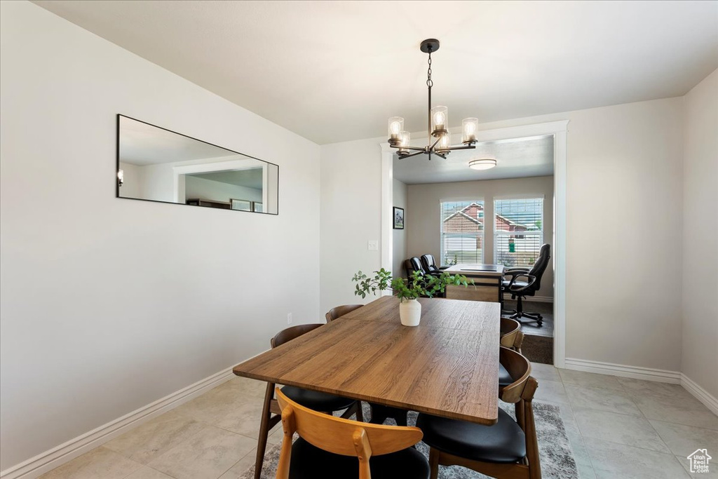 Tiled dining area with a notable chandelier