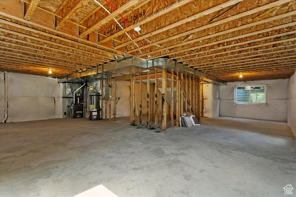 Basement with water heater and electric panel