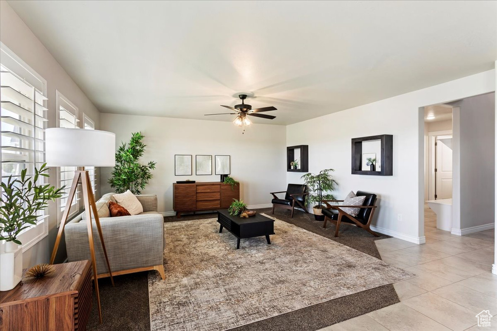 Tiled living room featuring ceiling fan