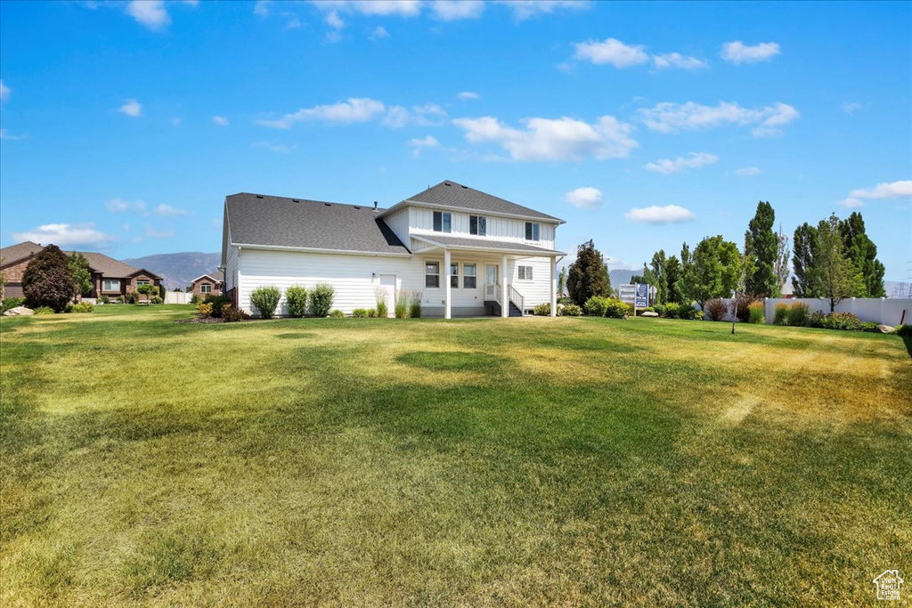 Rear view of property featuring a yard