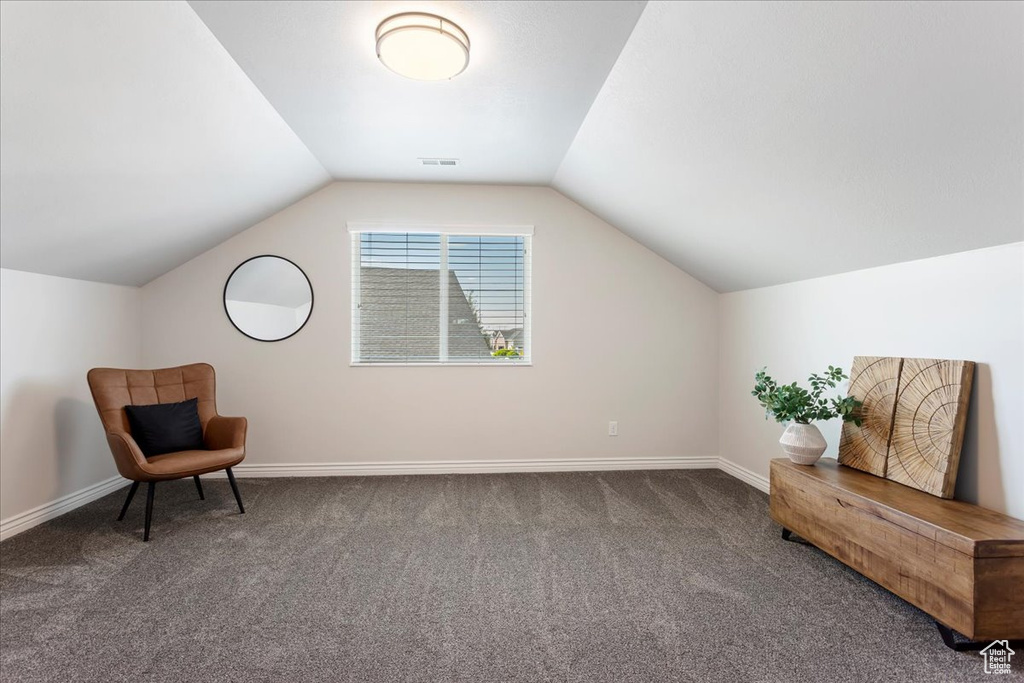 Sitting room featuring carpet and lofted ceiling