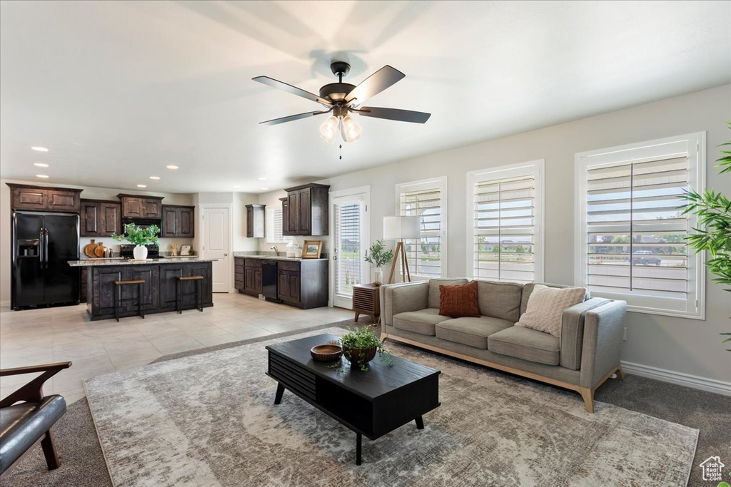 Living room with ceiling fan and light tile patterned floors