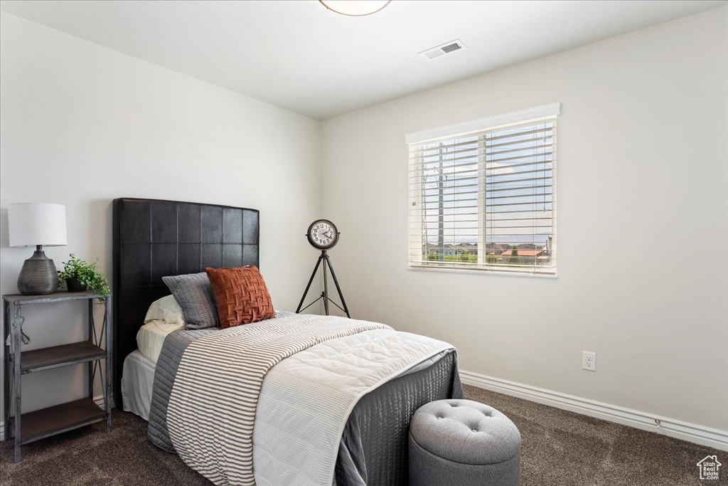 Bedroom featuring dark carpet