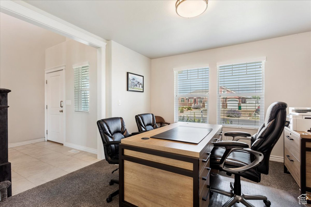 Office area featuring light tile patterned floors and plenty of natural light