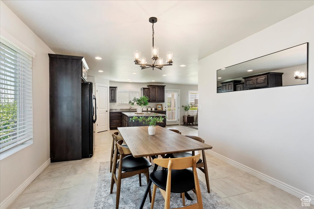 Dining space featuring a notable chandelier and light tile patterned floors