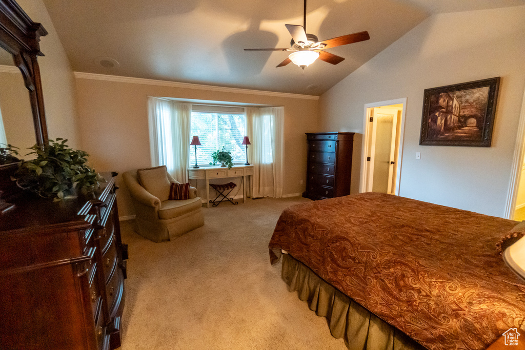 Carpeted bedroom featuring ceiling fan and lofted ceiling