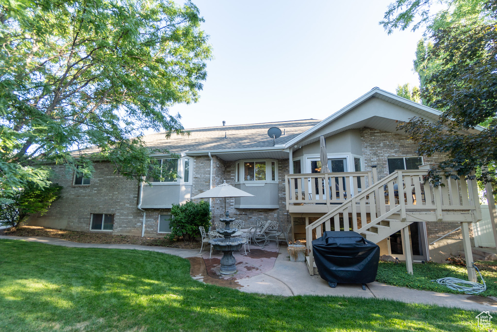 Rear view of property featuring a patio and a yard