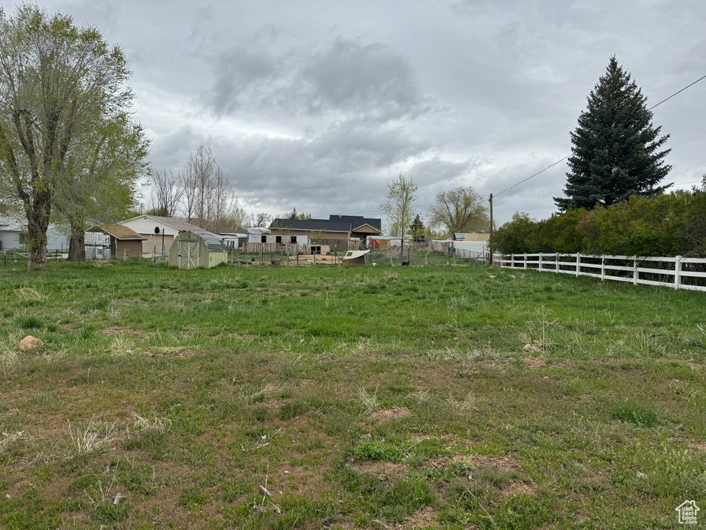 View of yard featuring a rural view and a shed