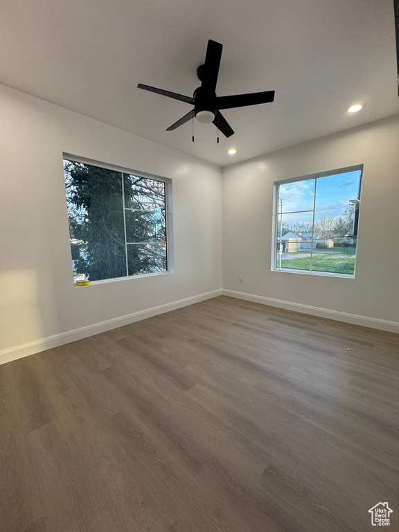 Spare room featuring plenty of natural light, wood finished floors, and recessed lighting