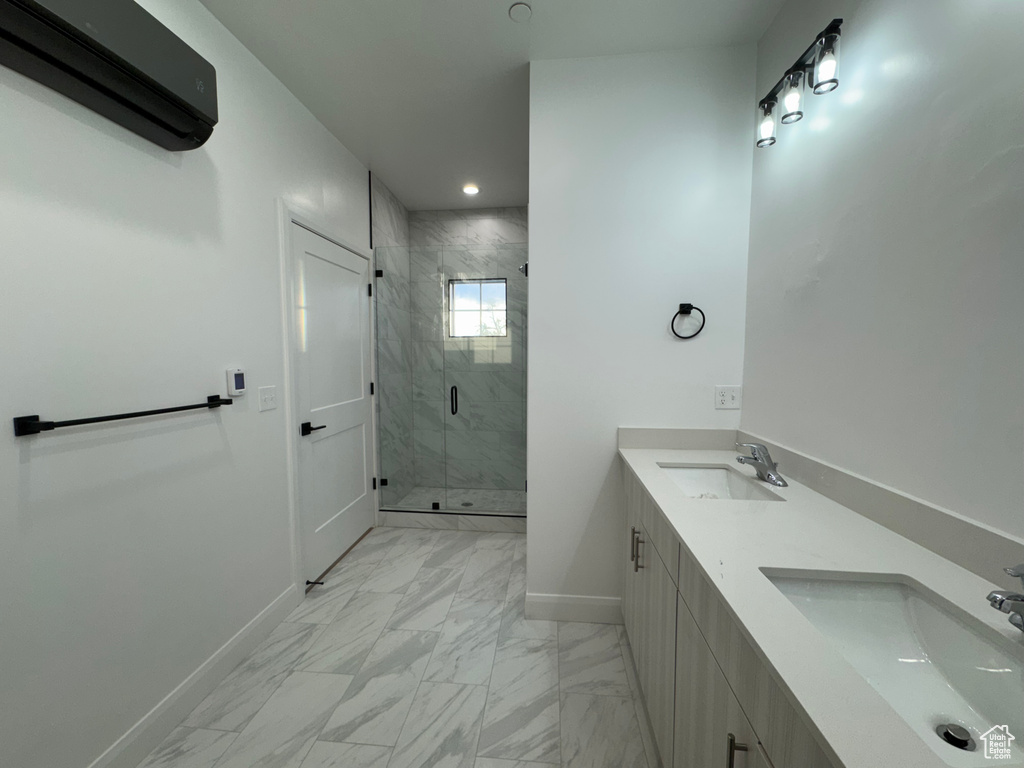 Full bathroom with baseboards, marble finish floor, a wall mounted AC, and a sink
