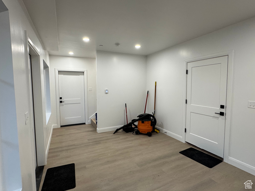 Entryway featuring light wood-style floors, baseboards, and recessed lighting