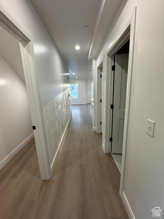 Corridor featuring recessed lighting, baseboards, and wood finished floors
