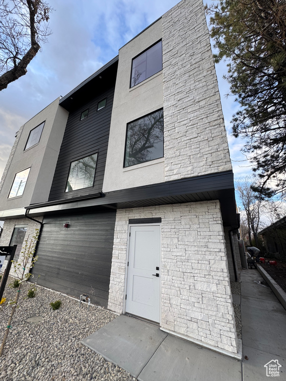 View of front facade featuring stucco siding