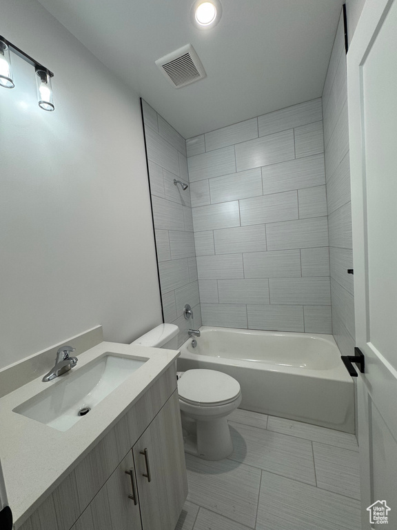Full bath featuring toilet, visible vents, tile patterned flooring, vanity, and shower / bathtub combination
