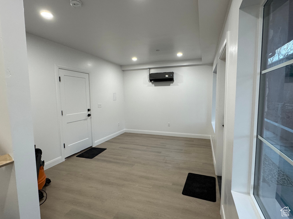 Below grade area with wood finished floors, baseboards, and recessed lighting