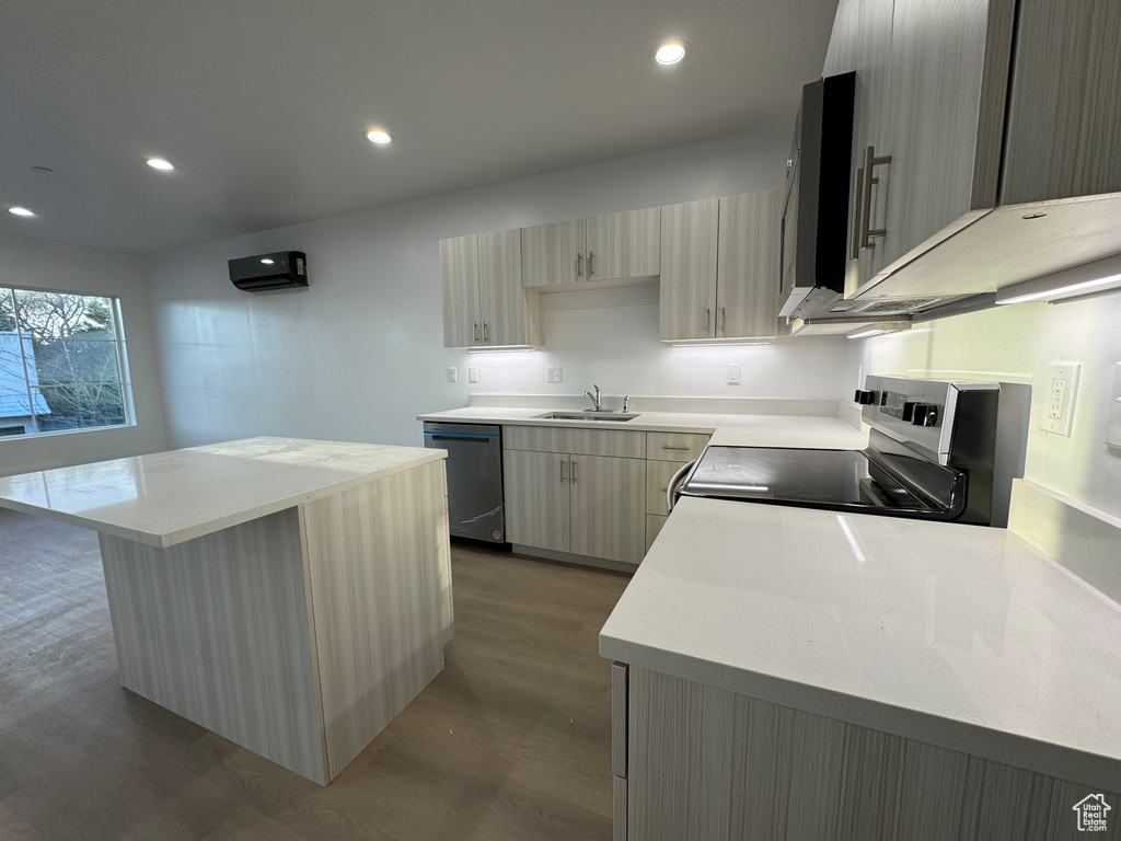 Kitchen featuring light countertops, appliances with stainless steel finishes, and dark wood-type flooring