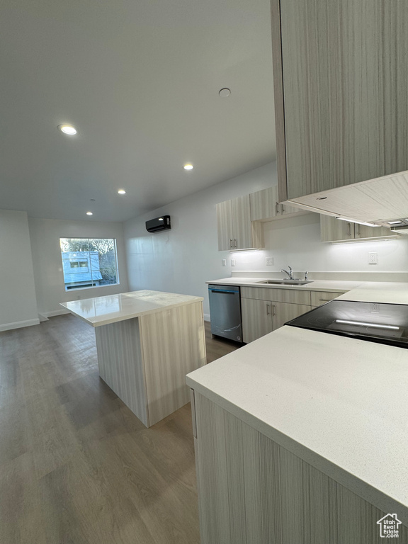 Kitchen featuring dishwasher, wood finished floors, modern cabinets, and light countertops