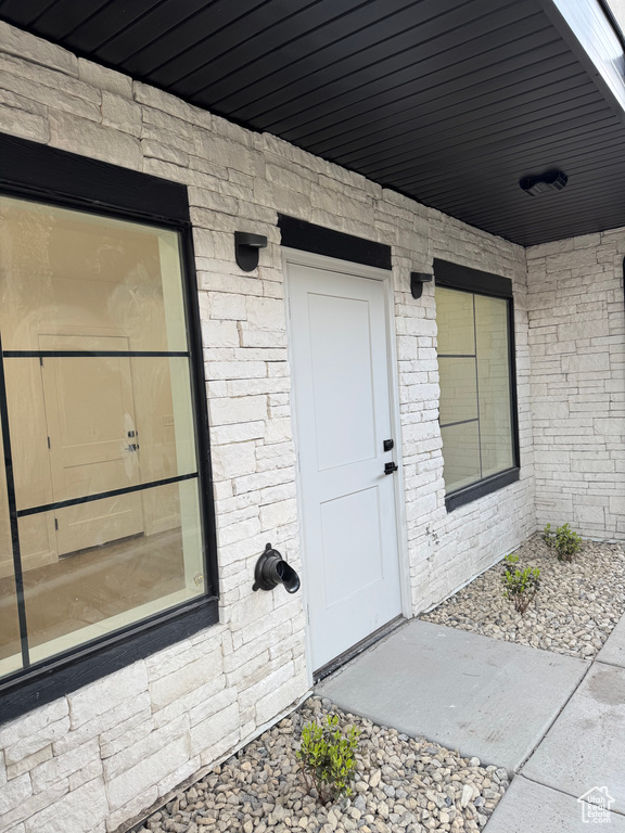 Doorway to property with brick siding