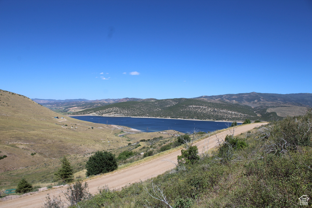 Property view of mountains featuring a water view