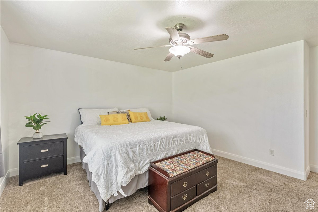 Bedroom featuring ceiling fan and light carpet