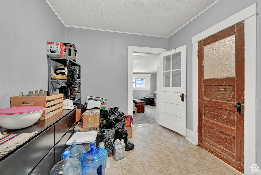 Interior space with light tile patterned flooring and ornamental molding